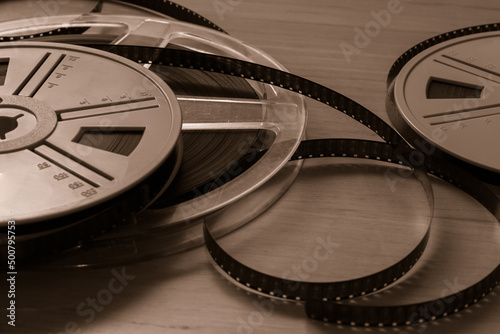 Vintage 8 mm film reels on wooden background. Copy space. Selective focus. photo