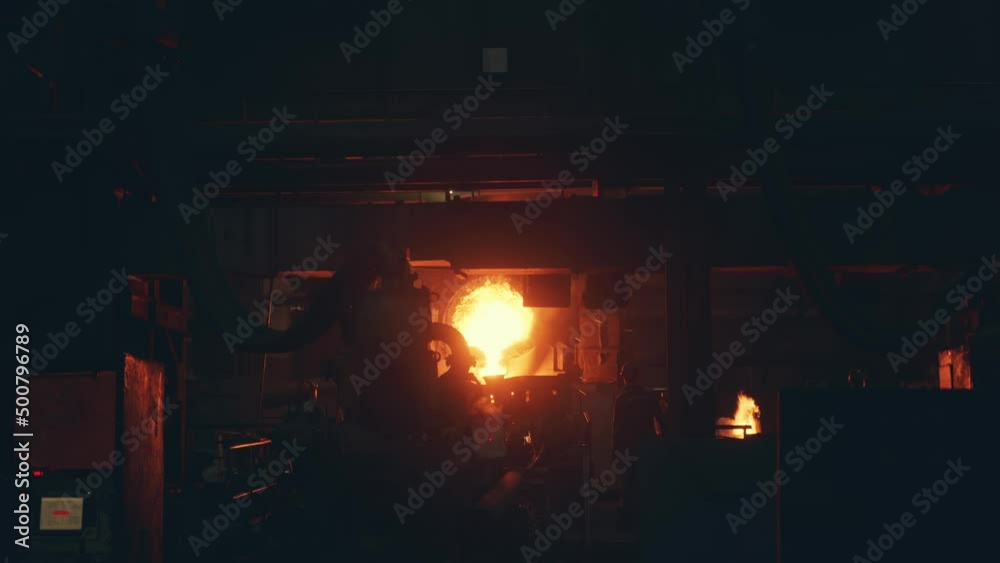Iron casting process in metallurgical factory. molten metal pouring from ladle in workshop. Iron casting process in metallurgical factory. molten metal pouring from ladle in workshop.