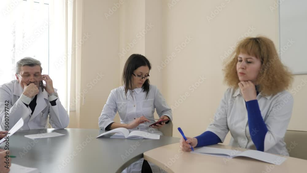 Team of caucasian doctors having a meeting in conference room. Healthcare and science concept. Meeting in a modern hospital building Team of caucasian doctors having a meeting in conference room. Healthcare and science concept. Meeting in a modern hospital building