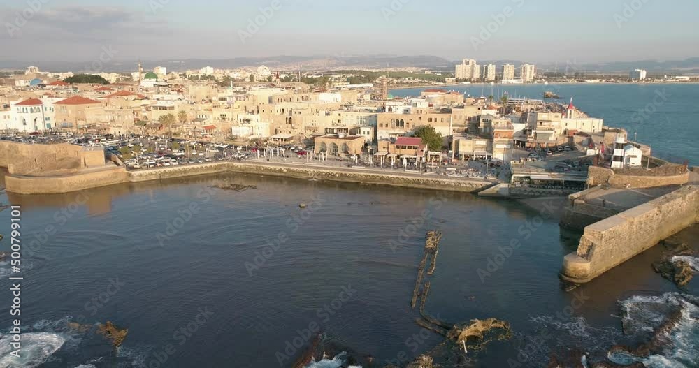 Aerial view of a passenger boat sailing near the natural water pool in Acre old town, Israel. Aerial view of a passenger boat sailing near the natural water pool in Acre old town, Israel.