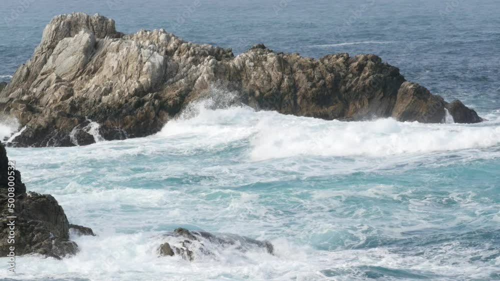 Rocky craggy ocean beach. Big waves crashing on bare cliff, blue water splashing, sea foam. Power of nature near Big Sur, 17-mile drive. Dramatic seascape. Point Lobos, Monterey, California coast, USA Rocky craggy ocean beach. Big waves crashing on bare cliff, blue water splashing, sea foam. Power of nature near Big Sur, 17-mile drive. Dramatic seascape. Point Lobos, Monterey, California coast, USA