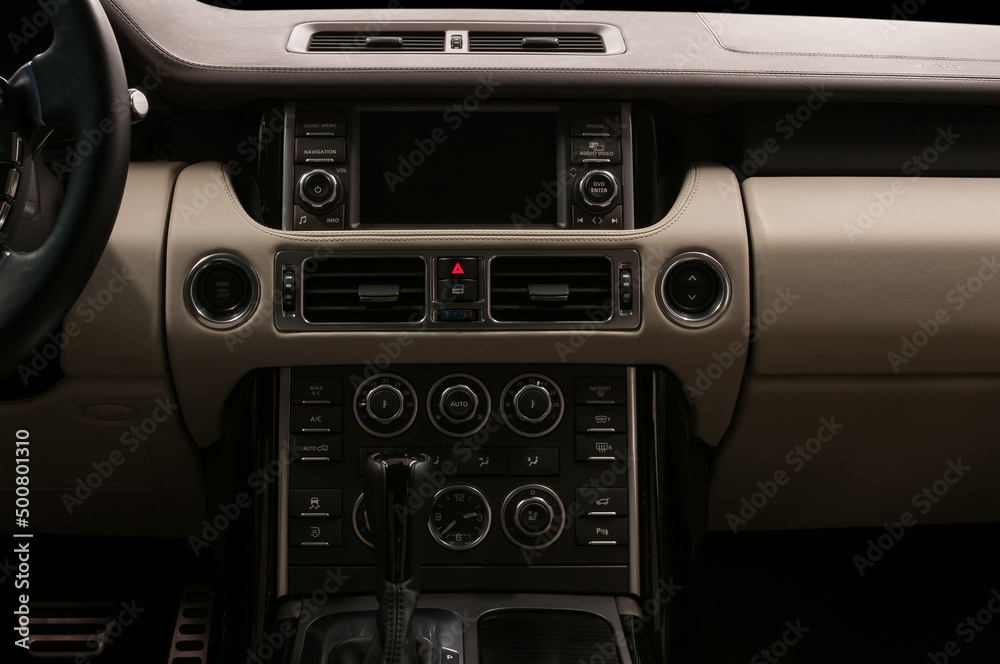 Luxury car interior. Multimedia screen and control buttons. Modern car inside.