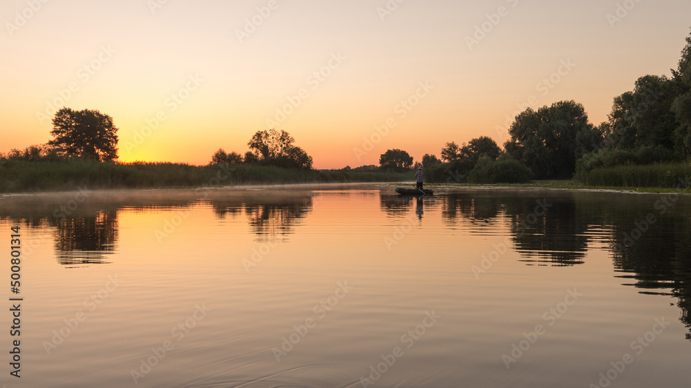 Fishermen on rubber boat early morning in river. Rural landscape.