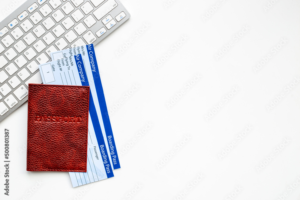 Booking tickets online - passport with air tickets on keyboard Booking tickets online - passport with air tickets on keyboard