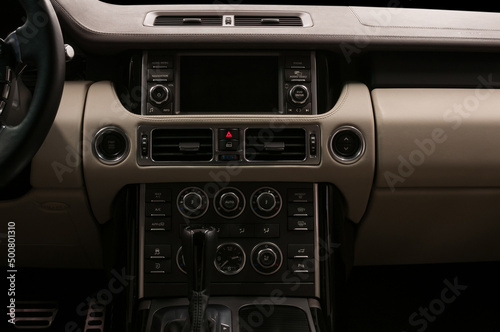 Luxury car interior. Multimedia screen and control buttons. Modern car inside. © alexdemeshko
