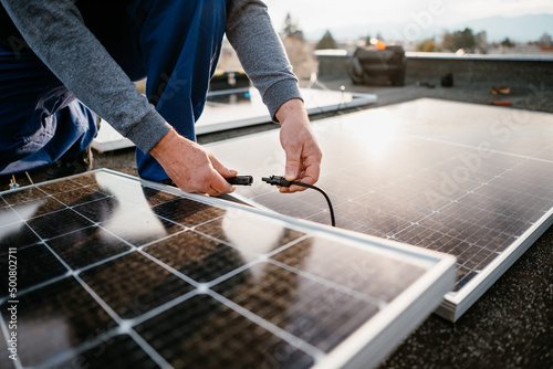 Worker installing solar energy panels. Alternative energy system. eco concept photo