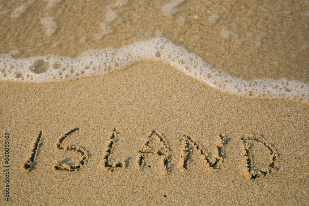 Fototapeta premium Island - handwritten on the soft beach sand.