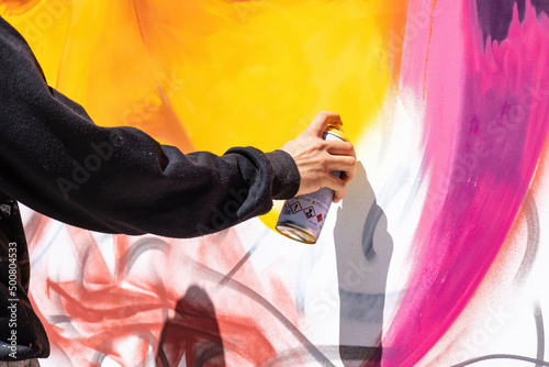 Hand of an urban artist creating a graffiti work art