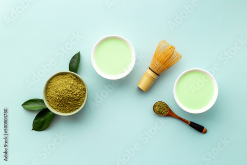 Green hot tea in bowls with matcha powder, top view