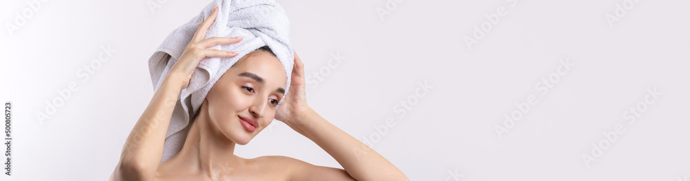 Beautiful girl with thick eyebrows and perfect skin at white background, towel on head, beauty photo. Beautiful girl with thick eyebrows and perfect skin at white background, towel on head, beauty photo.