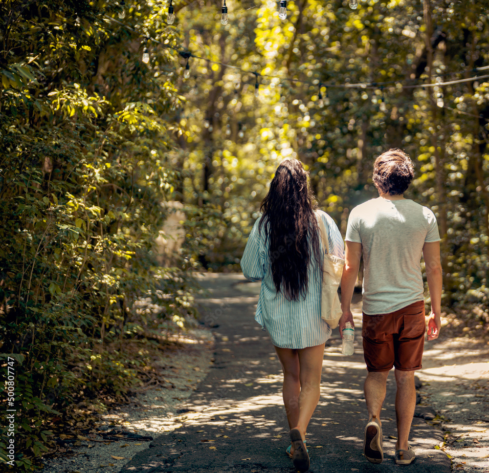 couple walking in the park summer miami couple walking in the park summer miami