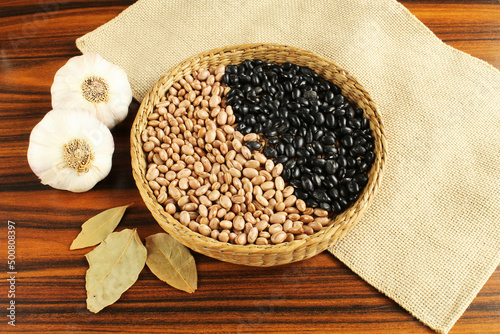 Brazilian grains carioca beans and black beans in a wicker basket.