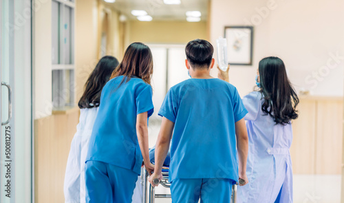Group of professional medical doctor team and assistant with stethoscope in uniform taking seriously injured coma patient to operation emergency theatre room in hospital.health medical care concept photo