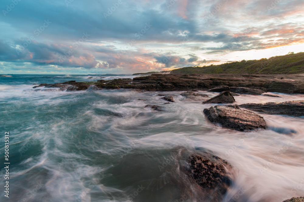 Fototapeta premium Water flowing between rocks on the coastline.