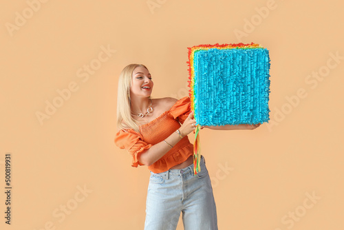 Smiling young woman holding...