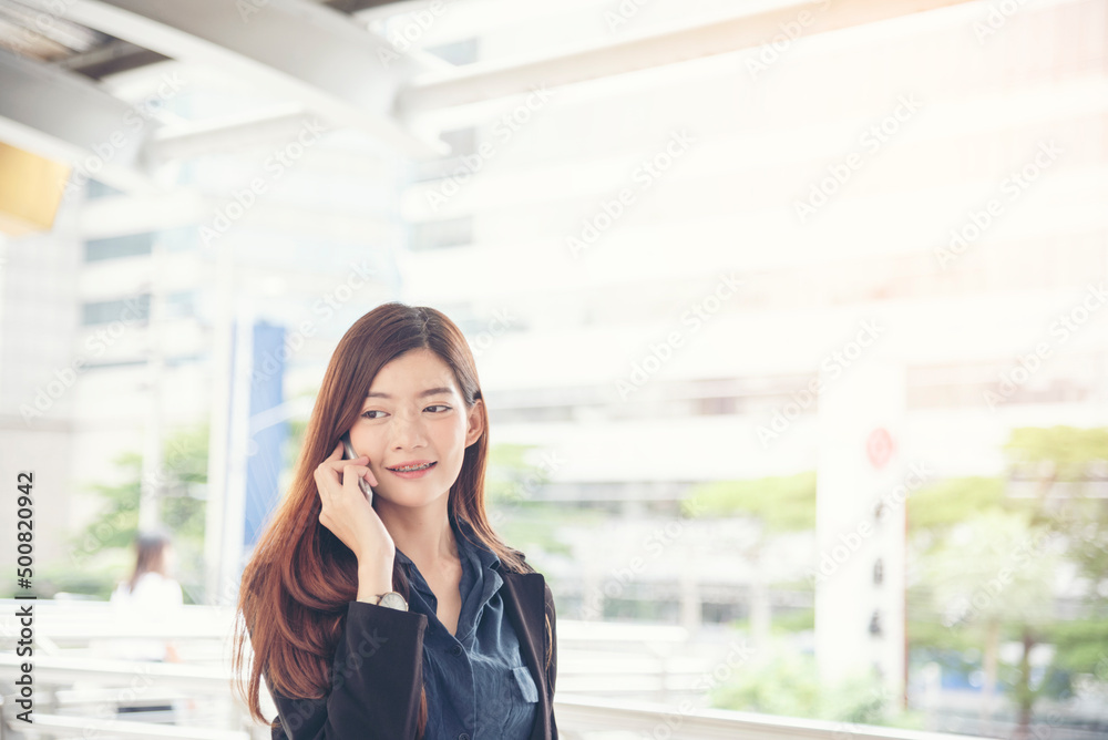 Business woman using smartphone shopping online, call, texting message internet technology lifestyle. Asian woman using cellphone walking on city street. Smart phone smart confident woman modern city Business woman using smartphone shopping online, call, texting message internet technology lifestyle. Asian woman using cellphone walking on city street. Smart phone smart confident woman modern city