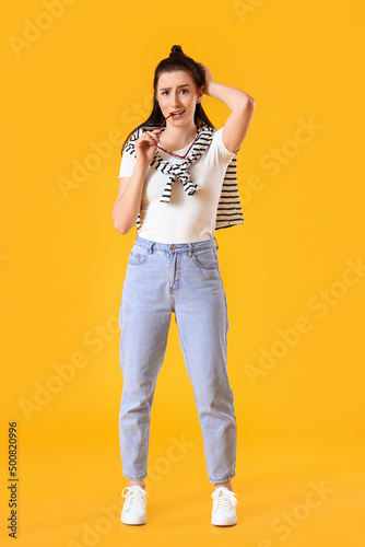 Worried young woman on yell...