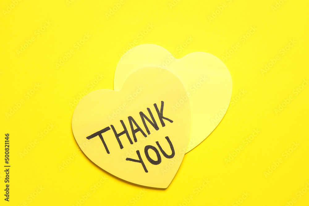 Heart shaped sticky notes with text THANK YOU on yellow background Heart shaped sticky notes with text THANK YOU on yellow background