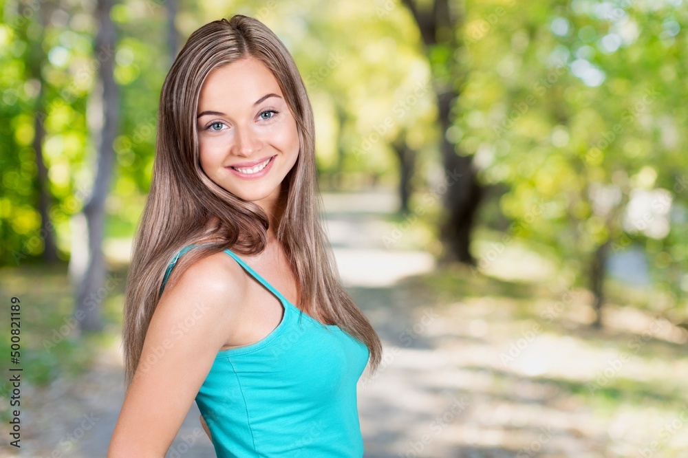 Young smiling woman walks at the park Young smiling woman walks at the park