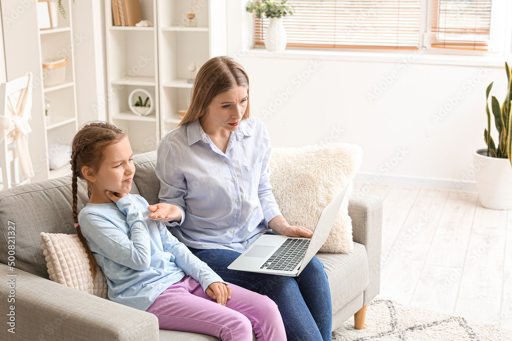 Little girl suffering from sore throat and her mother video chatting with doctor at home Little girl suffering from sore throat and her mother video chatting with doctor at home