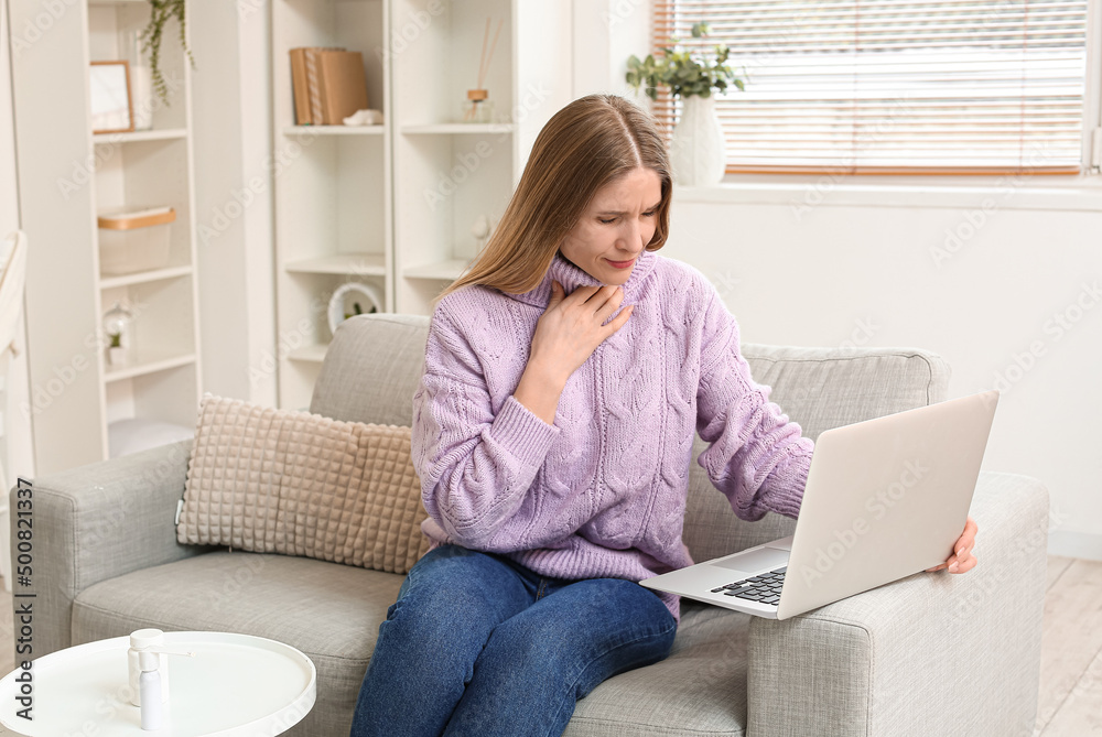 Beautiful woman suffering from sore throat and video chatting with doctor at home Beautiful woman suffering from sore throat and video chatting with doctor at home
