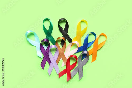 Set of awareness ribbons on green background. World Cancer Day concept