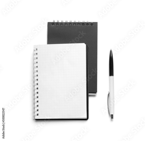 Notebooks and pen on white background, top view