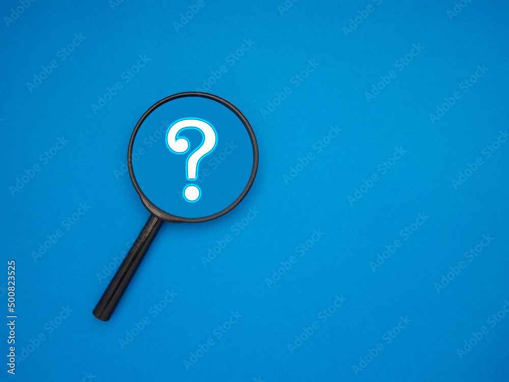 A magnifying glass with a question mark symbol over a blue background A magnifying glass with a question mark symbol over a blue background