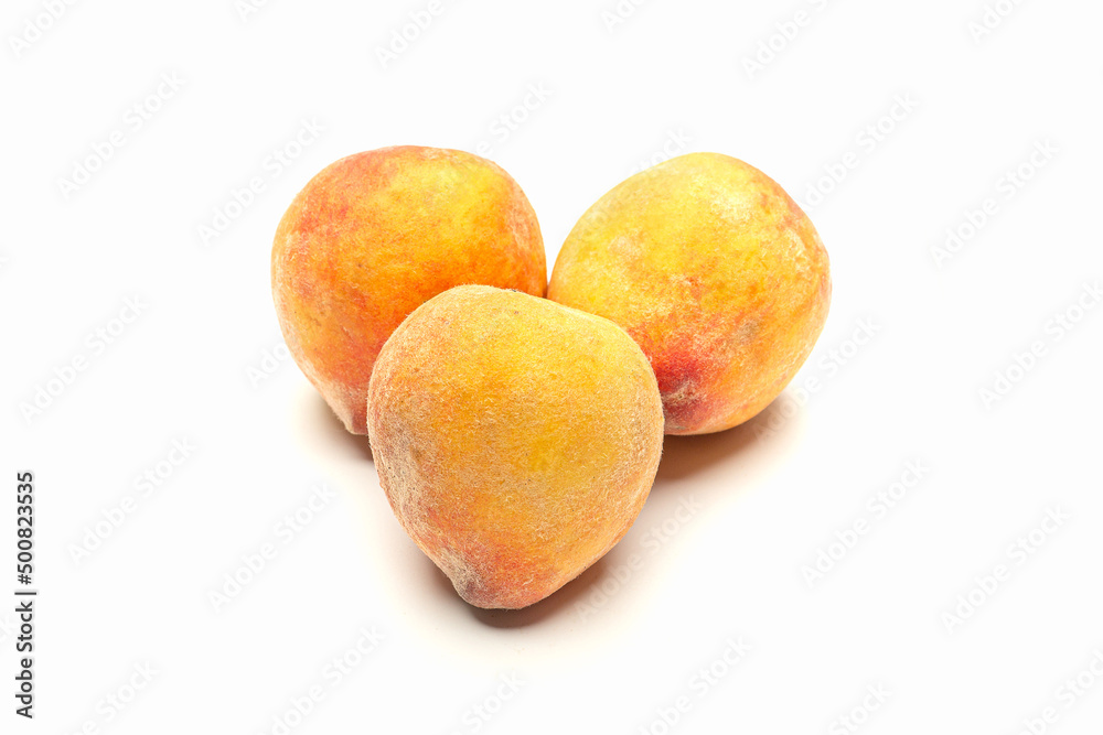 Group of fresh peaches fruit over a white background
