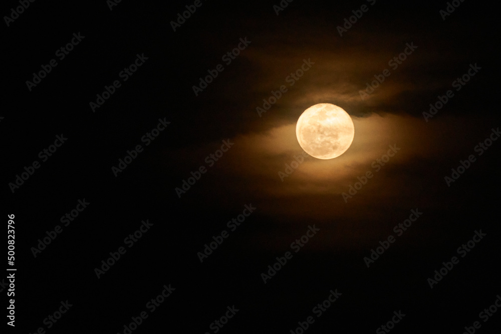 view of the full moon with few clouds