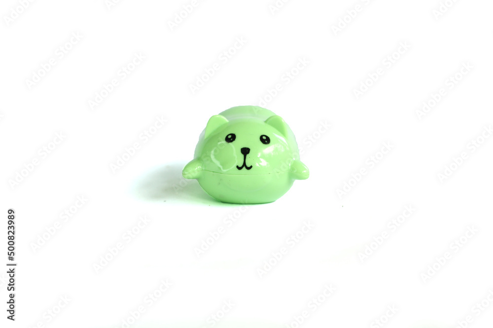 green plastic cat toy lying down isolated on white background. Decorative kawaii style pet. Soft plastic toy. green plastic cat toy lying down isolated on white background. Decorative kawaii style pet. Soft plastic toy.