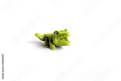 alligator, green crocodile toy made from rubber isolated on white background