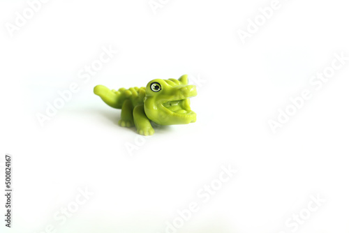 alligator, green crocodile toy made from rubber isolated on white background
