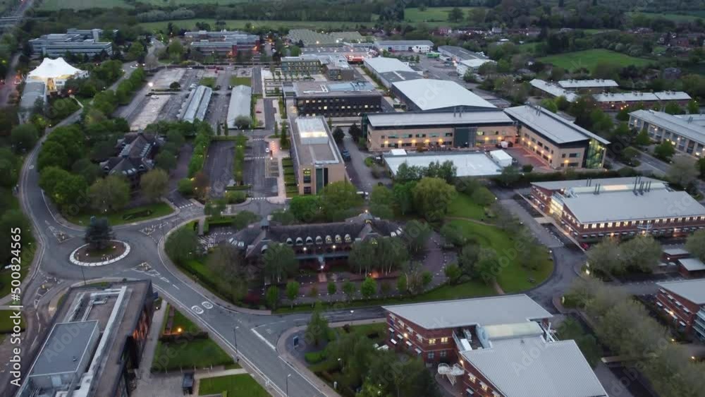 Flying slowly over a deserted business park in the UK at dusk. Countryside in b/g Flying slowly over a deserted business park in the UK at dusk. Countryside in b/g