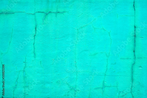 Rough vintage cracked bright green stucco background