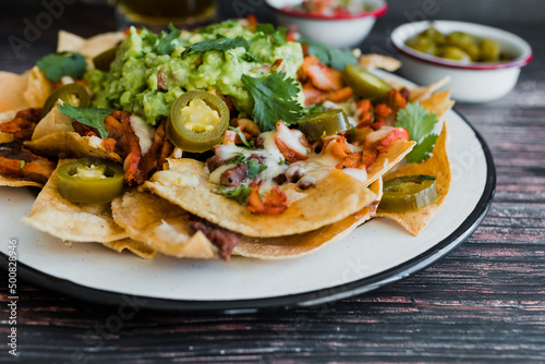Mexican nachos chips with american cheese and avocado, traditional food in Mexico Latin America