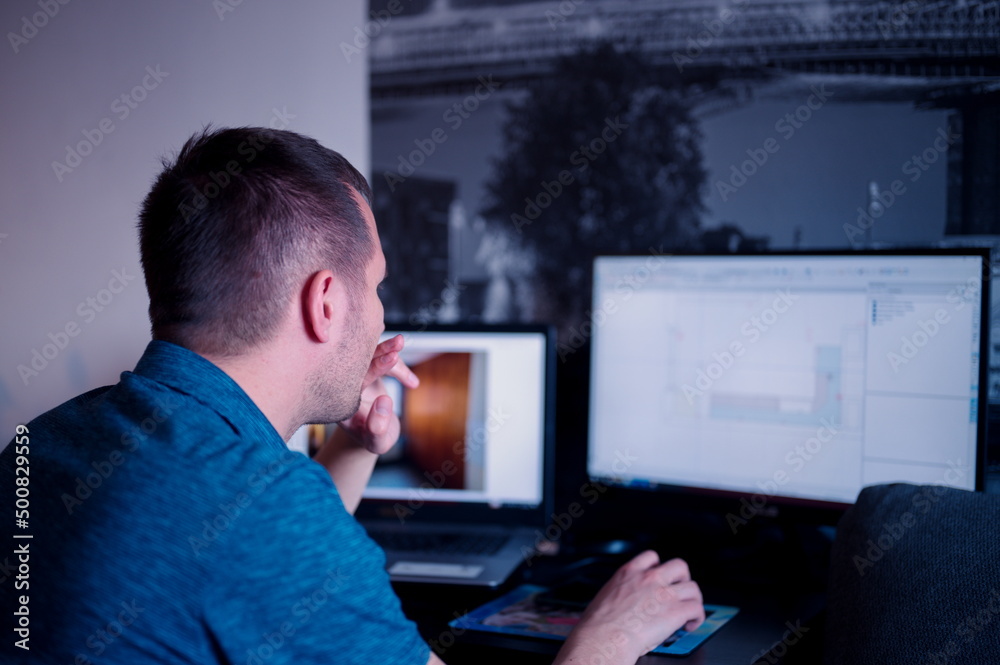 Mature man sitting at the table using computer for business Mature man sitting at the table using computer for business