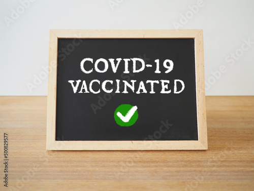 covid-19 vaccinatedと書かれた黒板 photo