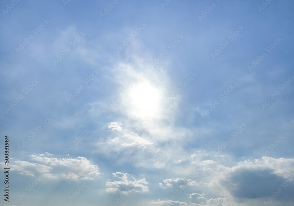 Strong sunlight, blue sky, cumulus clouds.