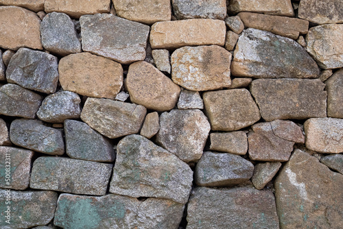 roadside stone wall. The texture of the stone.
