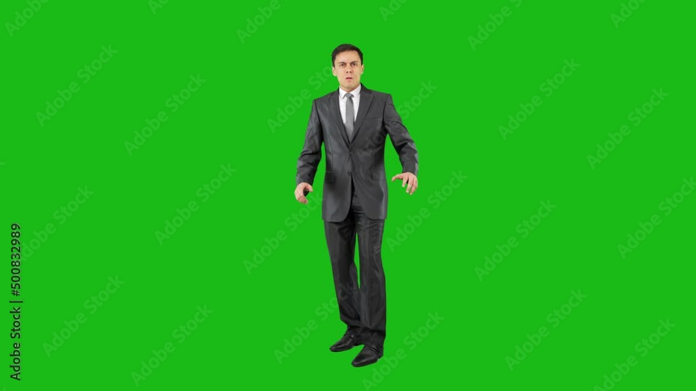 Surprised young businessman standing in studio and looking at camera Surprised young businessman standing in studio and looking at camera