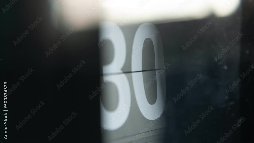 Numbers of minute on the clock changing continuously in time-lapse