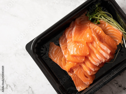 Fresh salmon sashimi in a lunch box