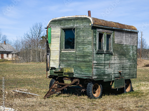 Old wooden wagon with wheels in sunny spring day.