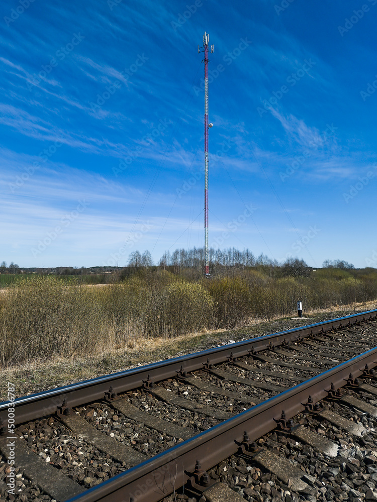 Railway tracks and 5g telecommunication antenna tower.