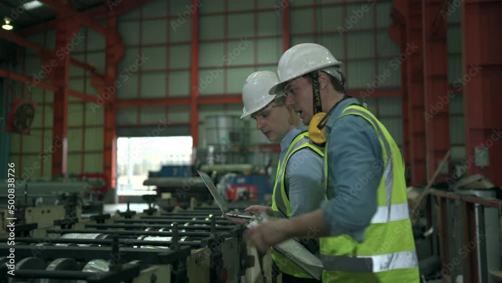 2 Industrial engineers working together in the factory. 2 Industrial engineers working together in the factory.