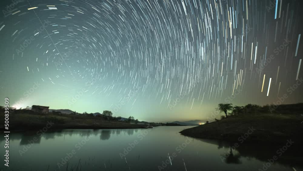 Circular star trails time lapse over the lake. Astro photography and Nightscape photography at Mandan Lake, Rajpipla, Gujarat
