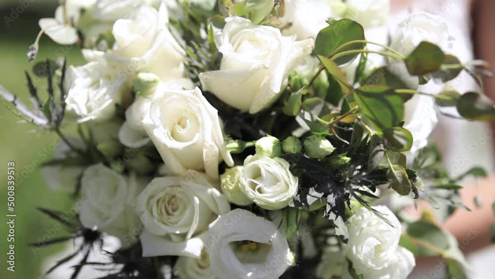Close Up of Bride in Her Wedding Dress Holding Large Flower Wedding Bouquet in Her Hands Outdoors with White Roses and Greenery 1080p 60fps Close Up of Bride in Her Wedding Dress Holding Large Flower Wedding Bouquet in Her Hands Outdoors with White Roses and Greenery 1080p 60fps