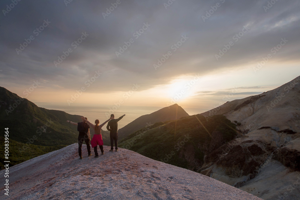 tourists stand on the mountain and admire the sunset, Sakhalin. Kuriles