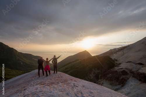 tourists stand on the mountain and admire the sunset, Sakhalin. Kuriles